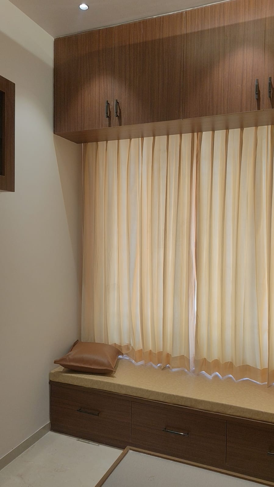 Bedroom window nook with loft overhead cabinets and designer curtains – Coimbatore villa