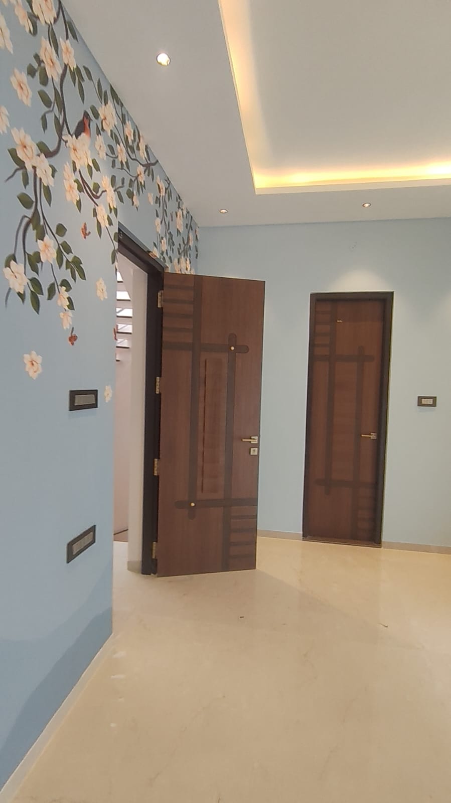 Custom hallway interior Coimbatore – floral wall mural with designer wooden doors